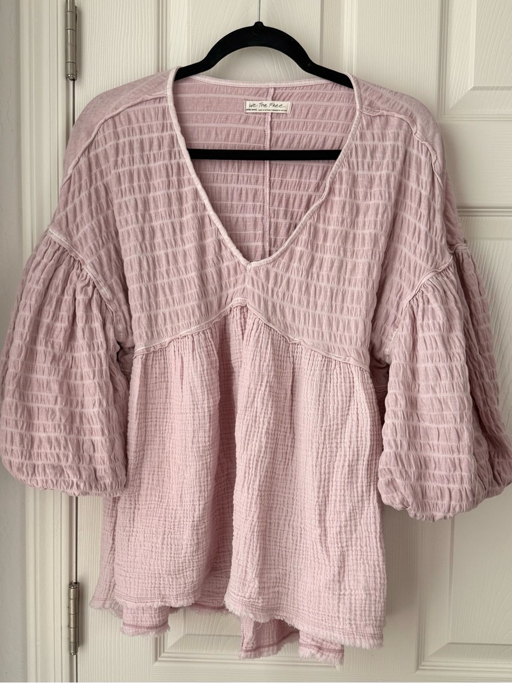 Free People "We The Free" puckered babydoll blouse in a soft pink/mauve hue